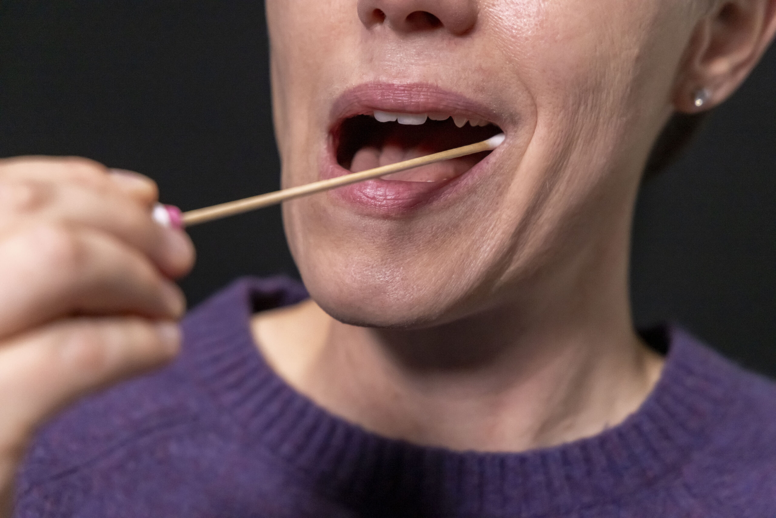 Client taking saliva sample to submit for frequency testing equipment at CBH Energetics