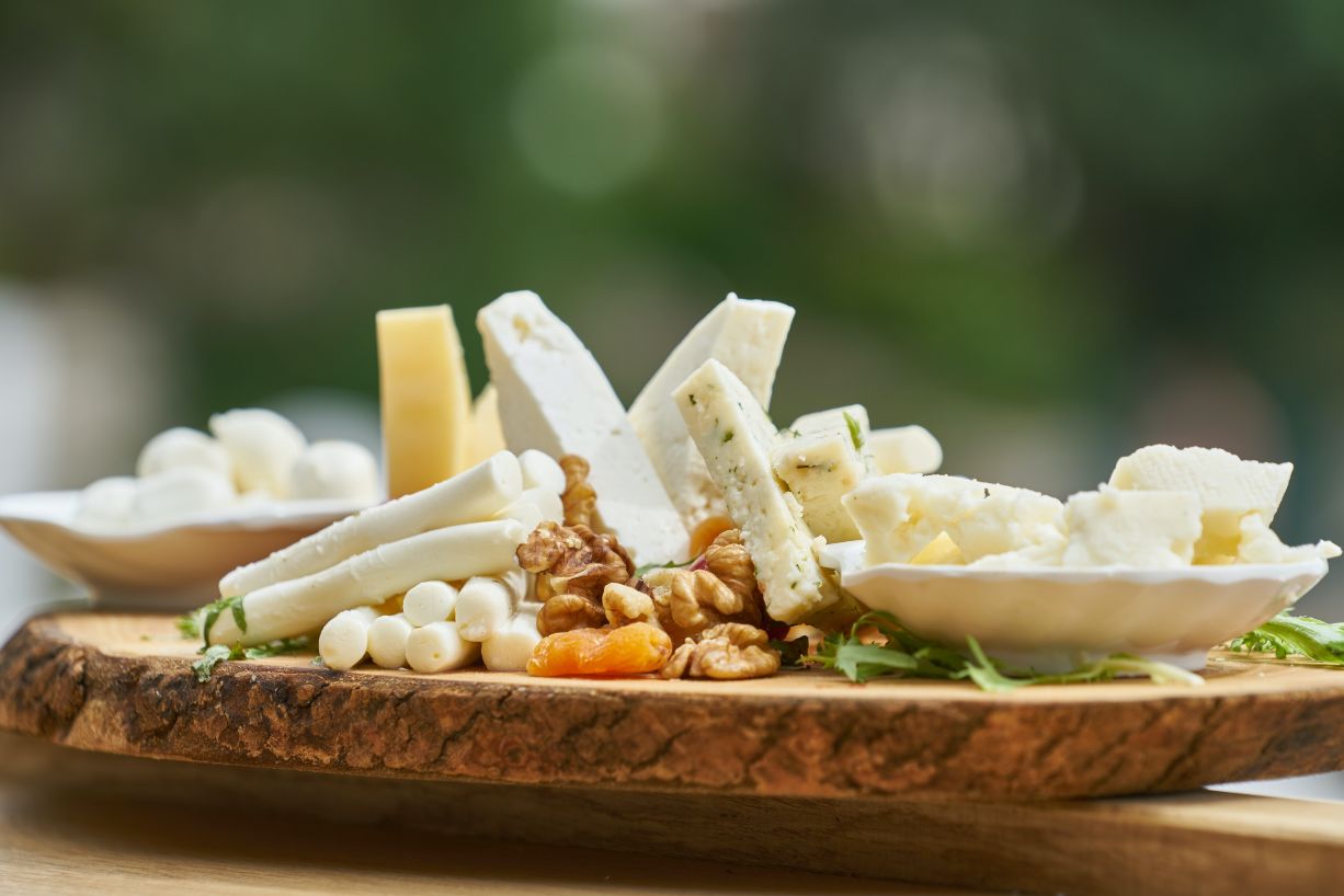 Cheese and walnuts on wooden platter
