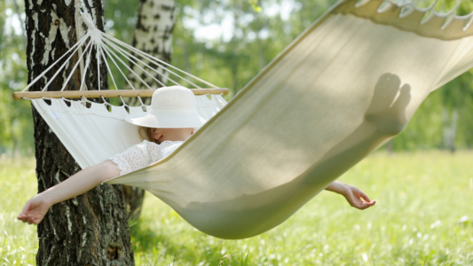 Woman sleeping in hammock prioritizing rest and down time