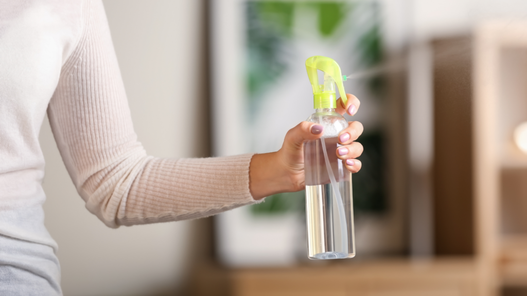 Woman's hand spraying a non toxic cleaner 