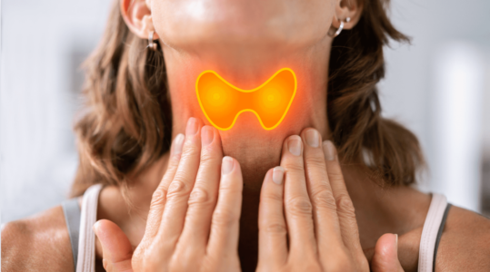 Close up shot of a woman touching her neck, a highlighted thyroid section is showing. 