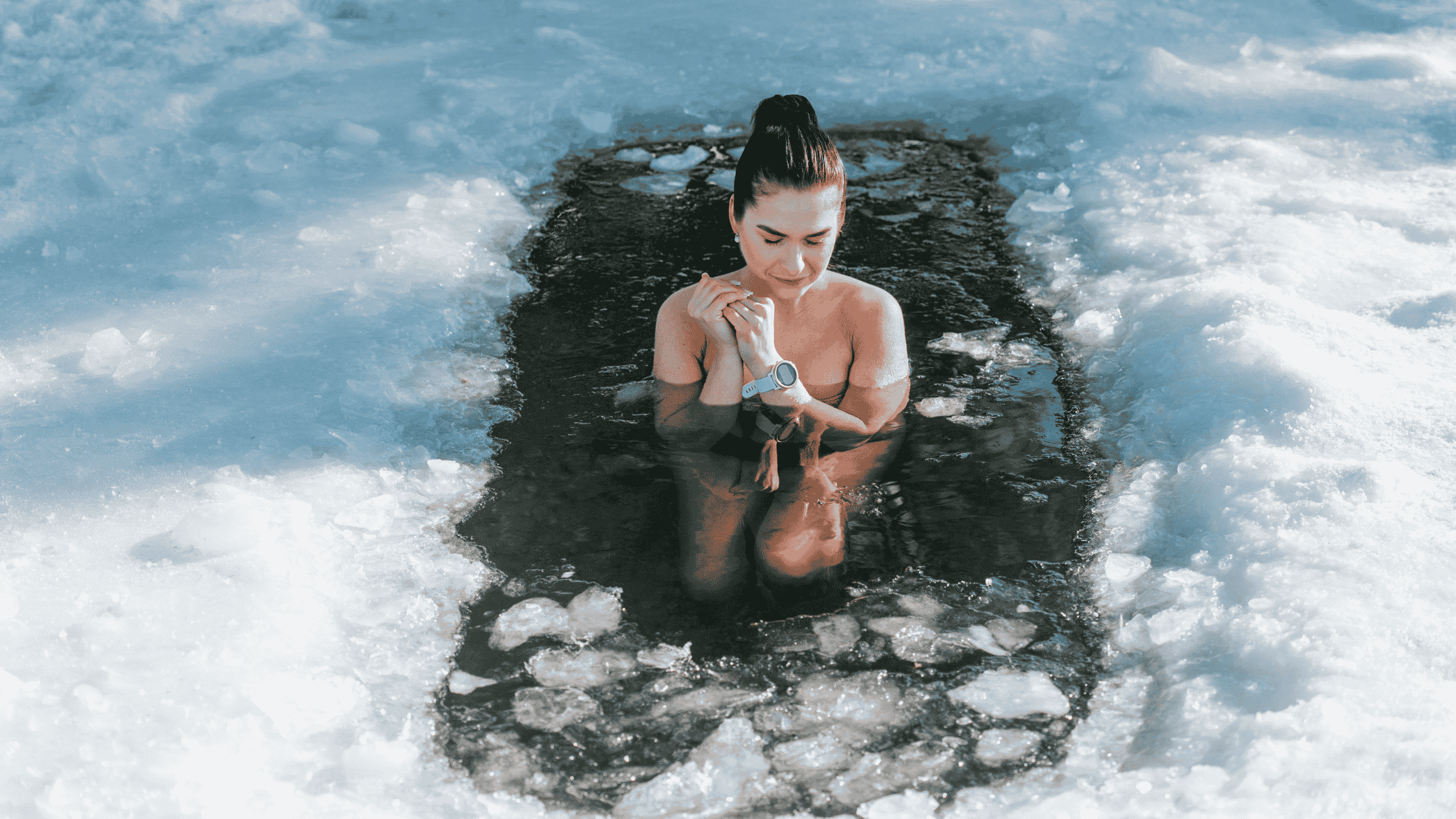 A woman in a icy lake doing cold water therapy.