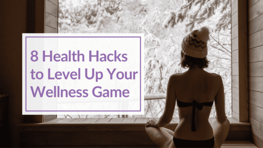 Woman in a bathing suit inside a sauna looking outside to snow covered landscape. Overlay text: 8 Health Hacks to Level Up Your Wellness Game