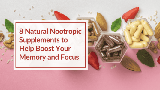 A pink and white background with a variety of hexagon bowls containing nutritional supplements. There are also various foods like strawberries and almonds. Overlay Text: 8 Natural Nootropic Supplements to Help Boost Your Memory and Focus