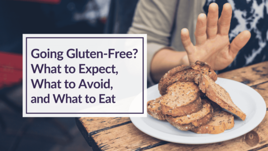 A person at a wooden table pushing away a plate of sliced toast. Overlay Text: Going Gluten-Free? What to Expect, What to Avoid, and What to Eat