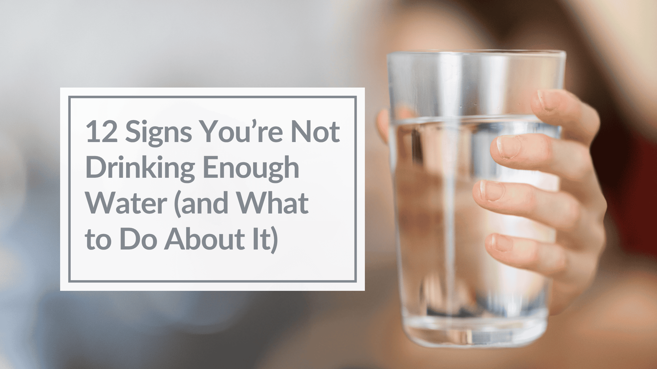 A closeup of a hand holding a glass o water. Overlay Text: 12 Signs You’re Not Drinking Enough Water (and What to Do About It)
