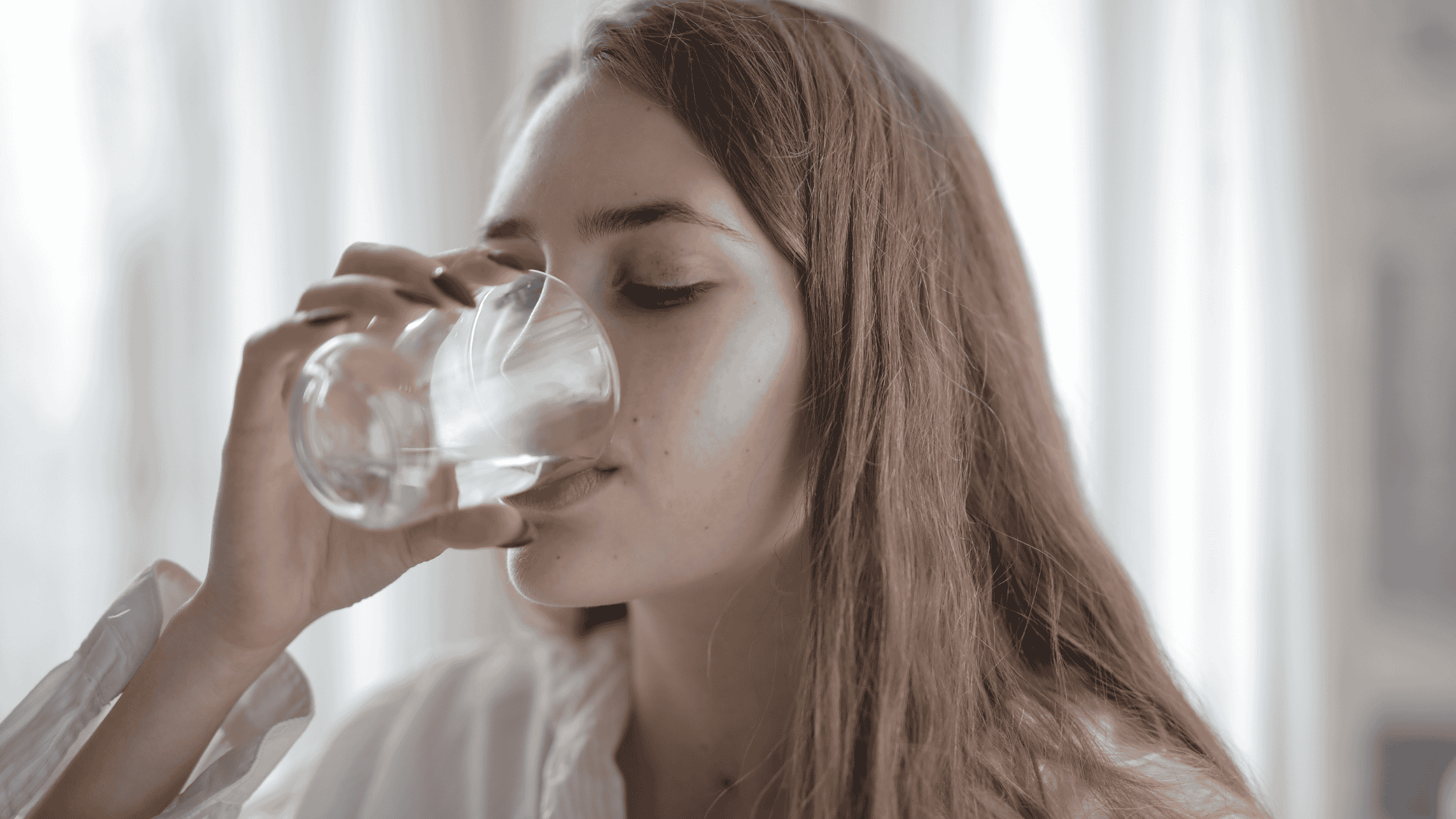 woman drinking a glass of water.