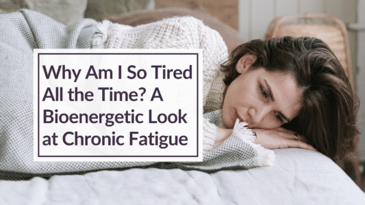 A woman looking tired, lying in bed. Overlay text reads: Why Am I So Tired All the Time? A Bioenergetic Look at Chronic Fatigue